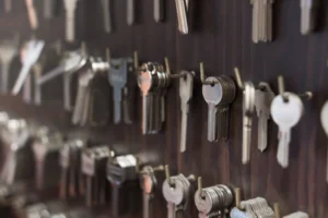 Wall-mounted display of various keys organized in rows for locksmiths. -locksmith services