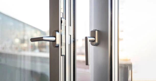 Modern glass door with silver handles and secure locking mechanism. -emergency locksmith services